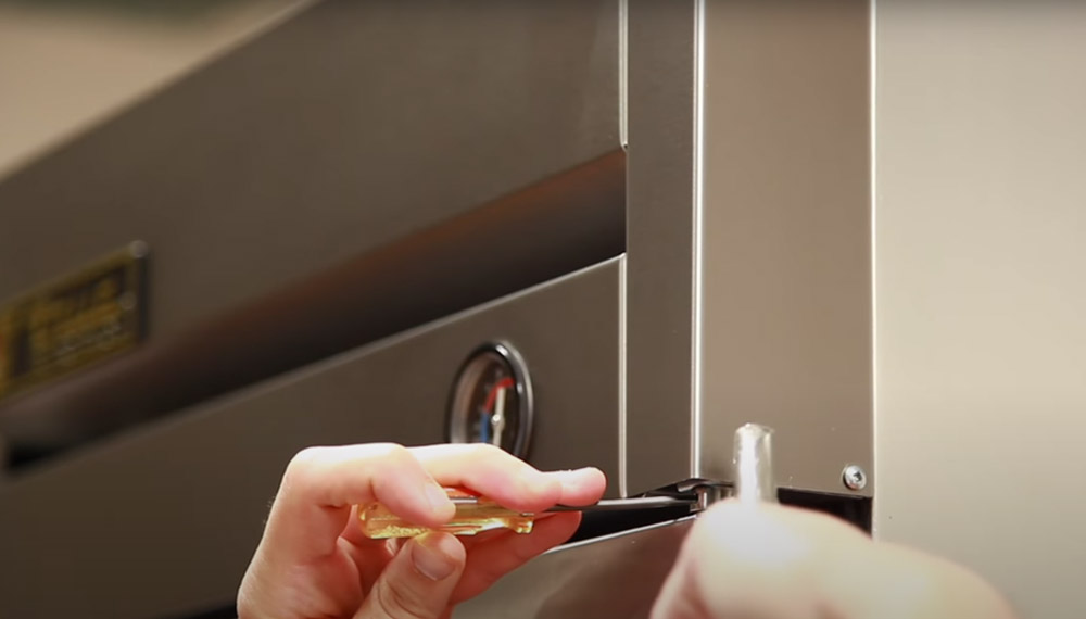 Upright refrigerator and freezer swing door tension adjustment